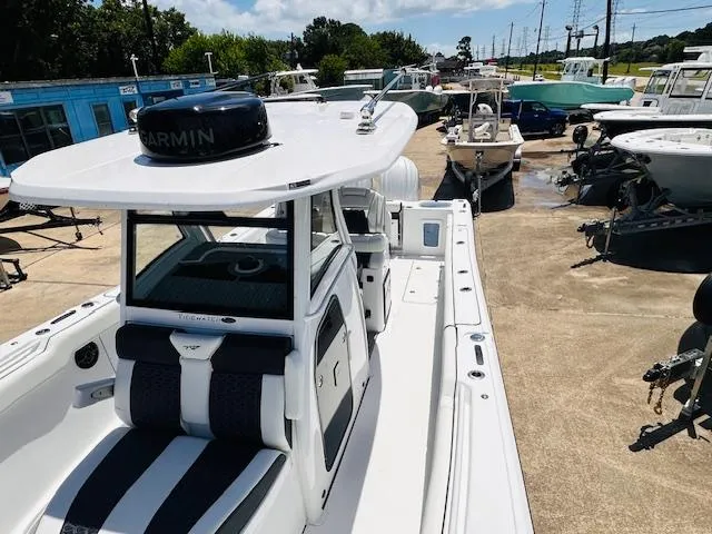 Slide: The Image of 2026 Tidewater 302 CC Adventure boat with Garmin equipment, docked in a marina. - 9