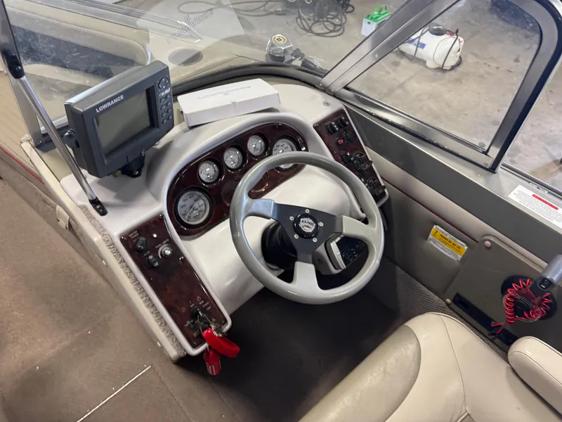 Slide: The Image of 2002 Lund 1850 Tyee Gran Sport boat dashboard with steering wheel and gauges. - 11