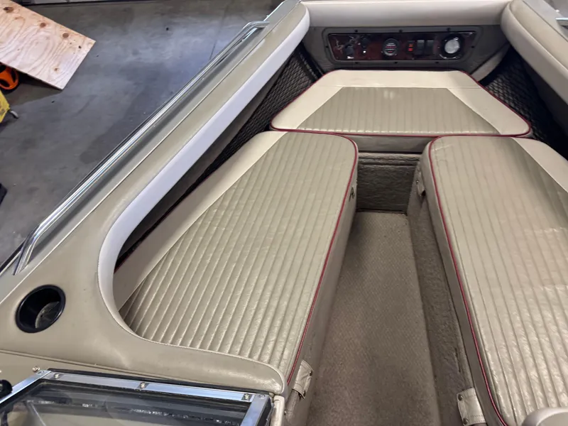 Slide: The Image of 2002 Lund 1850 Tyee Gran Sport boat interior with beige seating and control panel. - 13