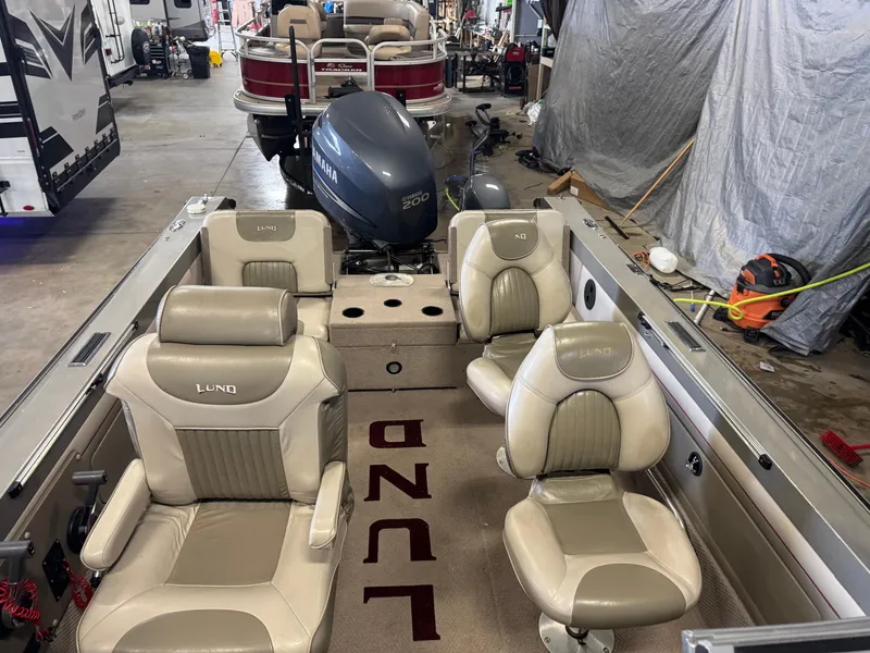 Slide: The Image of 2002 Lund 1850 Tyee Gran Sport boat interior with Yamaha engine in a garage setting. - 15