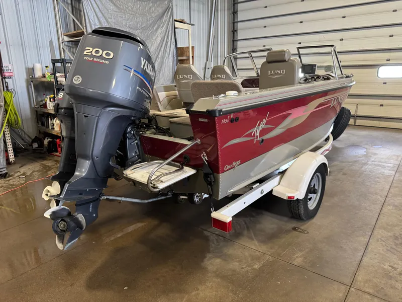 Slide: The Image of 2002 Lund 1850 Tyee Gran Sport boat with Yamaha 200 four-stroke engine in a garage. - 4