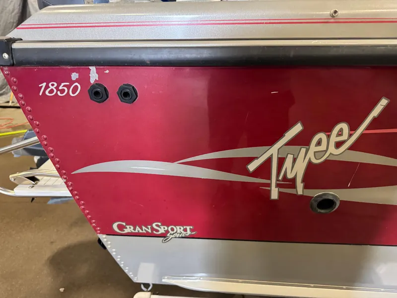 Slide: The Image of 2002 Lund 1850 Tyee Gran Sport boat, red and silver exterior detail. - 6