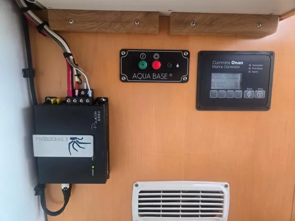 Slide: The Image of Control panel of a 2008 Fountaine Pajot Salina 48 yacht, featuring Aqua Base and Cummins Onan systems. - 13