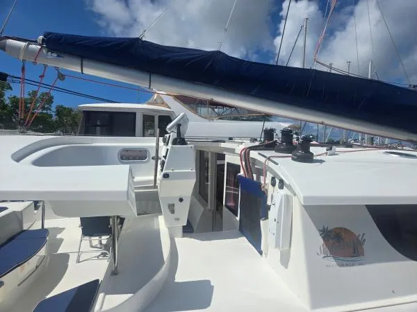 Slide: The Image of Fountaine Pajot Salina 48 catamaran, 2008 model, with sails and deck view under blue sky. - 19