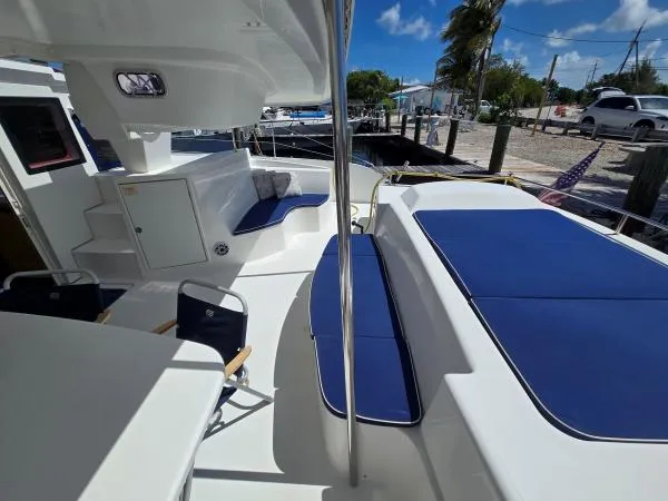 Slide: The Image of 2008 Fountaine Pajot Salina 48 catamaran deck with blue cushions and seating area. - 20