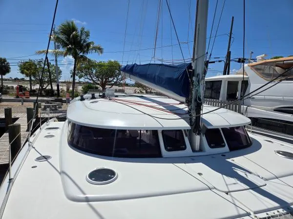Slide: The Image of 2008 Fountaine Pajot Salina 48 catamaran docked, featuring sleek design and spacious deck. - 22