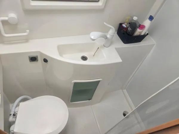 Slide: The Image of Compact bathroom in 2008 Fountaine Pajot Salina 48 catamaran, featuring sink, toilet, and toiletries. - 9
