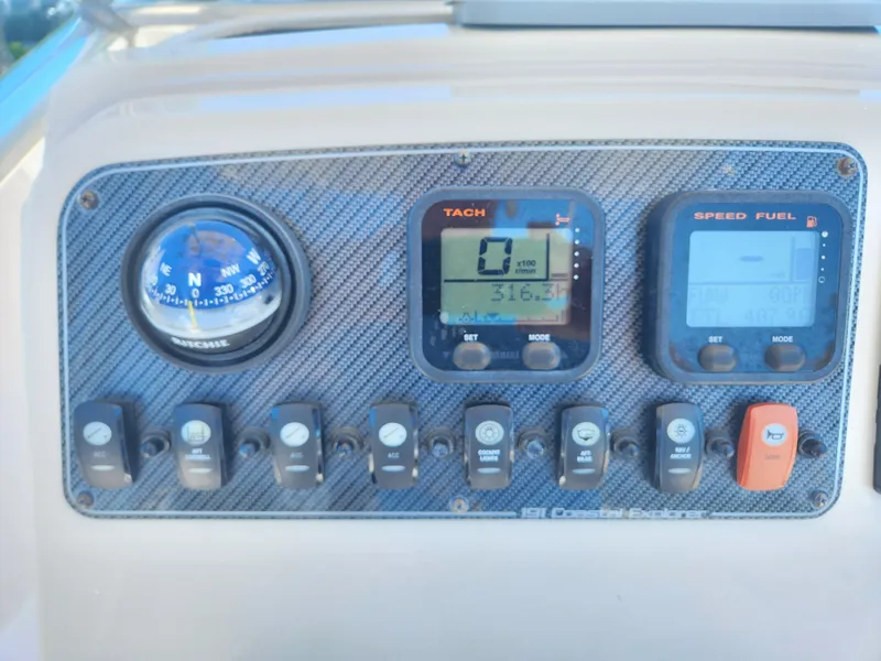 Slide: The Image of Control panel of 2015 Grady-White 191 Coastal Explorer with compass and gauges. - 13