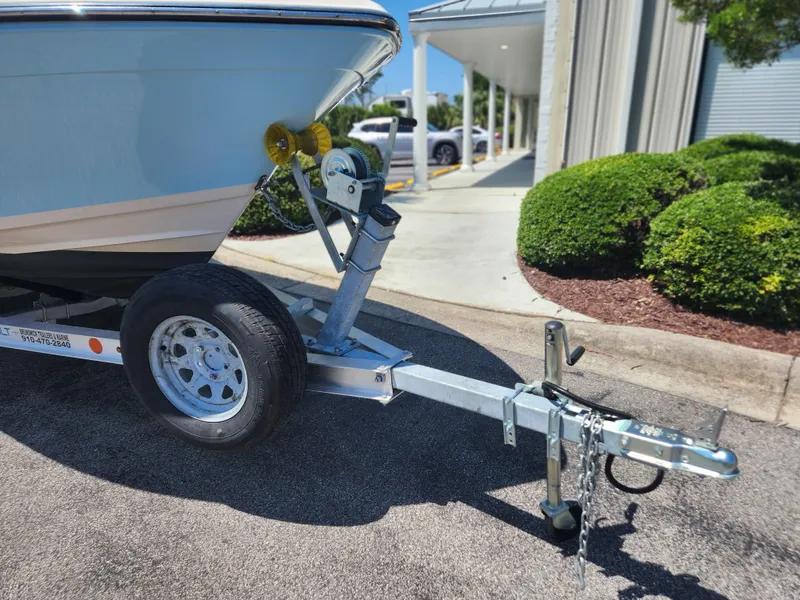 Slide: The Image of 2015 Grady-White 191 Coastal Explorer boat on trailer, parked outdoors. - 19