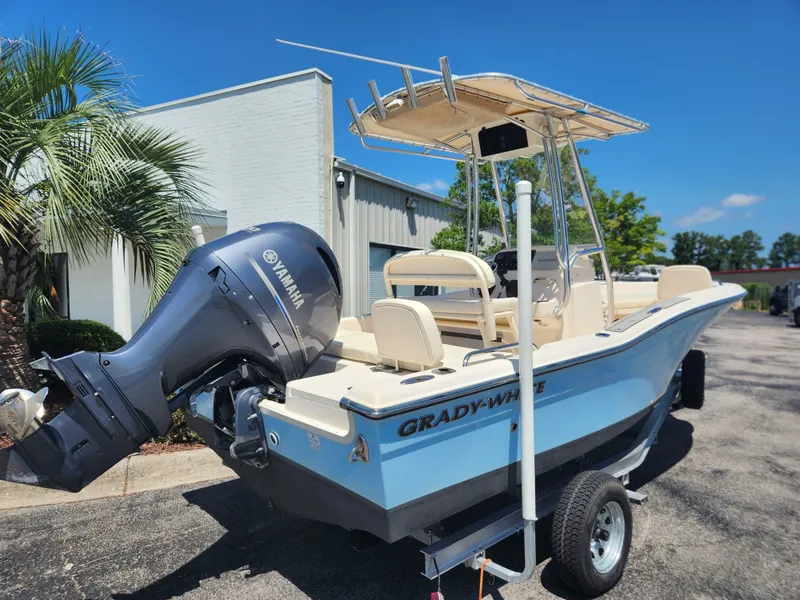 Slide: The Image of 2015 Grady-White 191 Coastal Explorer boat with Yamaha outboard motor, parked outdoors. - 2