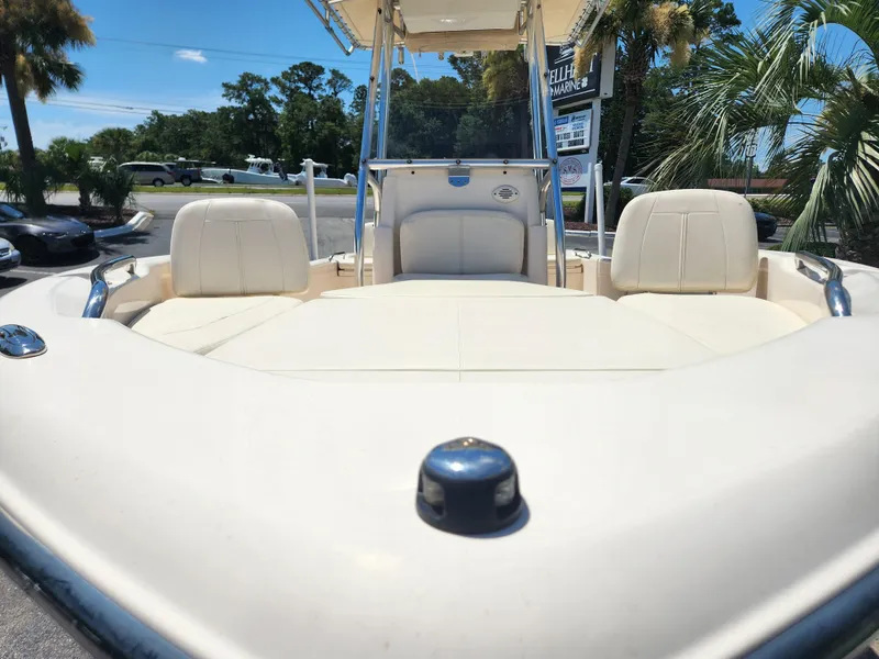 Slide: The Image of 2015 Grady-White 191 Coastal Explorer boat interior with seating and helm, parked outdoors. - 5