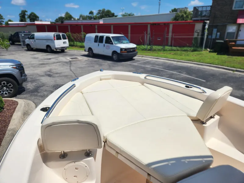 Slide: The Image of 2015 Grady-White 191 Coastal Explorer boat with cushioned seating, parked in a lot. - 7