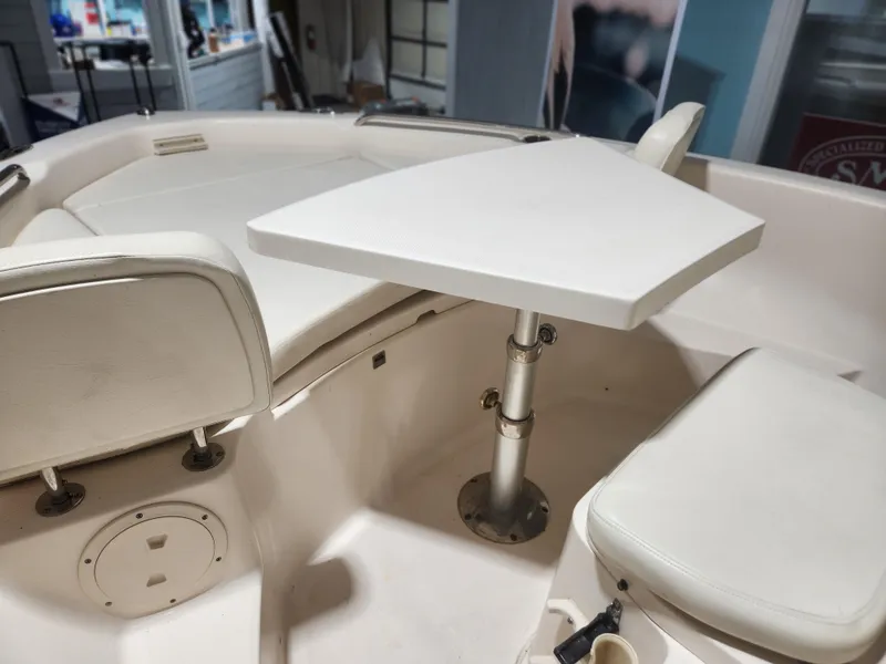 Slide: The Image of 2015 Grady-White 191 Coastal Explorer boat interior with seating and table setup. - 8