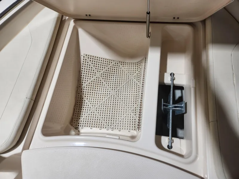 Slide: The Image of 2015 Grady-White 191 Coastal Explorer boat storage compartment with anchor and drainage area. - 9