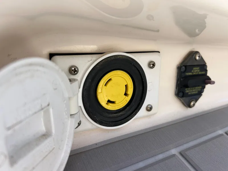 Slide: The Image of 2019 Grady-White Fisherman 236 boat power outlet and circuit breaker detail. - 20