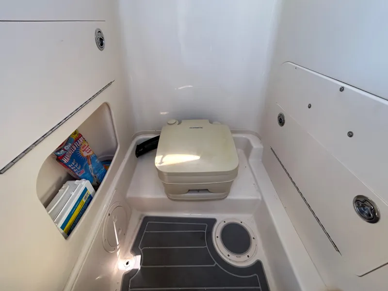 Slide: The Image of 2019 Grady-White Fisherman 236 boat interior with portable toilet and storage compartment. - 22