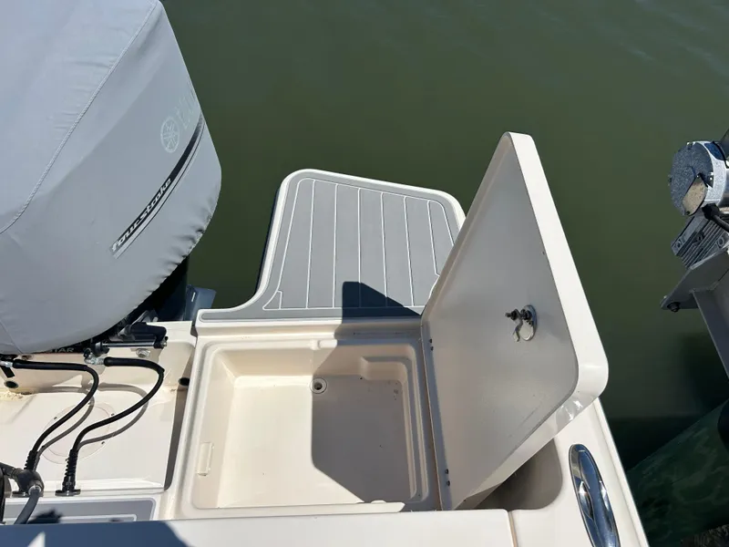 Slide: The Image of 2019 Grady-White Fisherman 236 boat with open storage compartment and covered engine. - 3