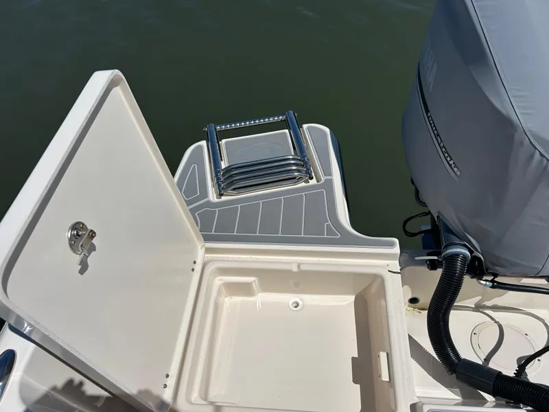 Slide: The Image of 2019 Grady-White Fisherman 236 boat with open storage compartment and covered outboard motor. - 4