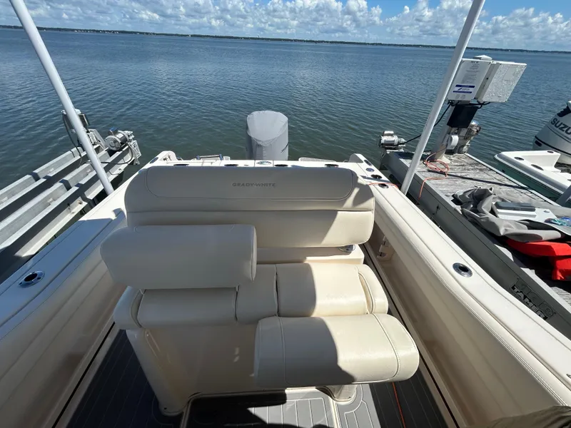 Slide: The Image of 2019 Grady-White Fisherman 236 boat interior with seating, docked by the water. - 8
