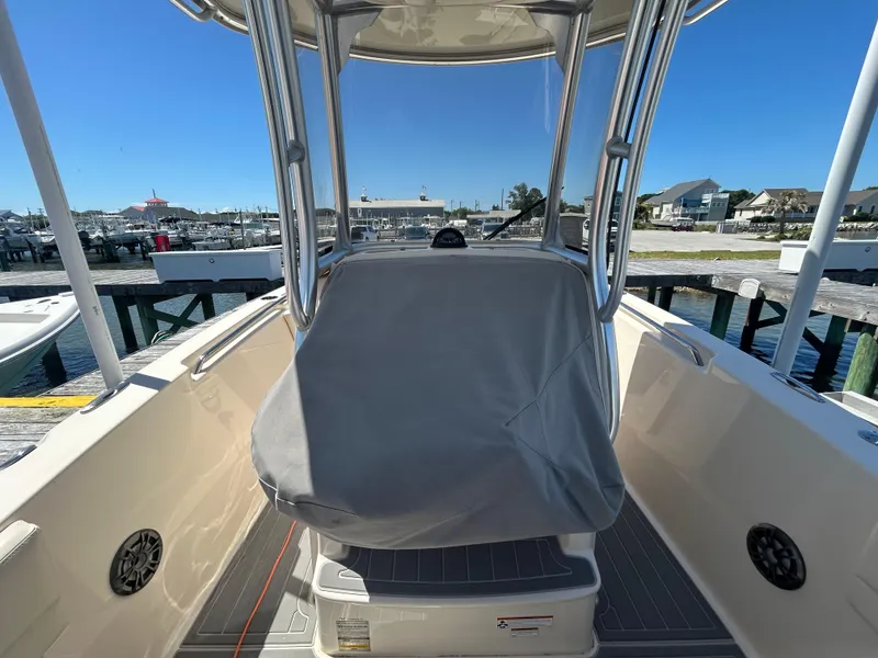 Slide: The Image of 2019 Grady-White Fisherman 236 boat interior at marina, featuring covered console and seating. - 9