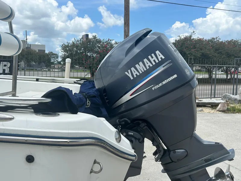 Slide: The Image of Yamaha four-stroke outboard motor on a 2004 Polar 184 boat, parked outdoors. - 4