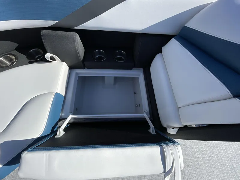 Slide: The Image of 2025 South Bay S222 Chill boat interior with open storage compartment and cup holders. - 13