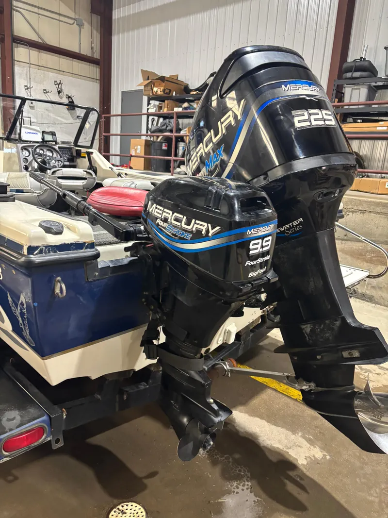 Slide: The Image of 1999 Warrior V193 boat with dual Mercury outboard motors in a garage setting. - 4