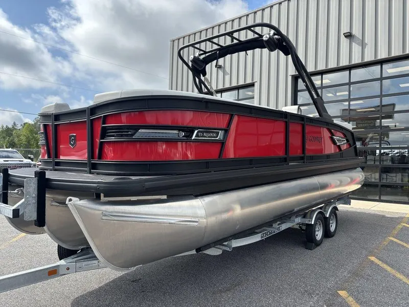 Slide: The Image of 2026 Godfrey AquaPatio 255 ULC pontoon boat in vibrant red, parked outdoors. - 11