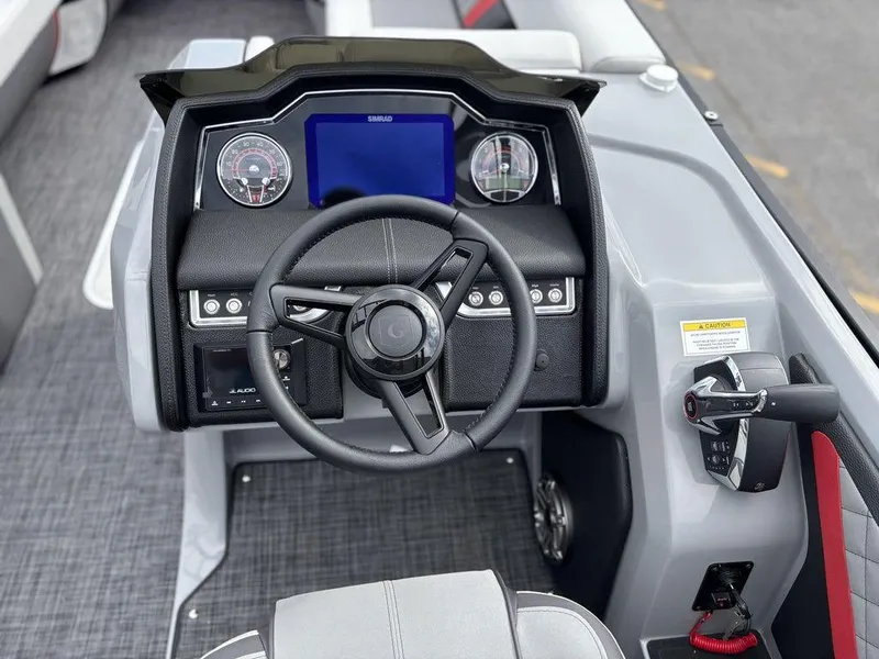Slide: The Image of Steering console of 2026 Godfrey AquaPatio 255 ULC boat with modern controls and display. - 14