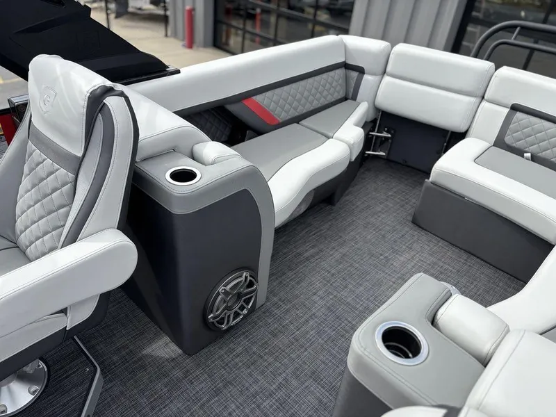 Slide: The Image of Luxurious interior of 2026 Godfrey AquaPatio 255 ULC pontoon boat with plush seating and cup holders. - 17