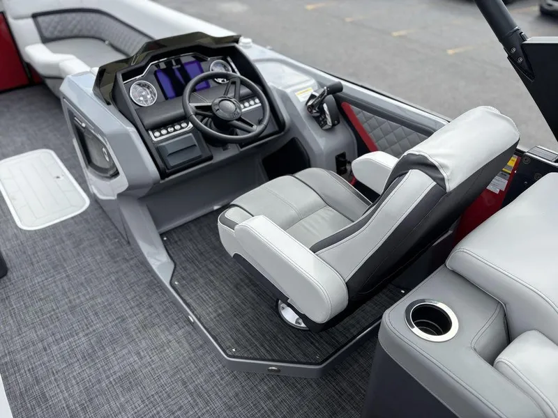 Slide: The Image of 2026 Godfrey AquaPatio 255 ULC boat interior with modern helm and comfortable seating. - 19