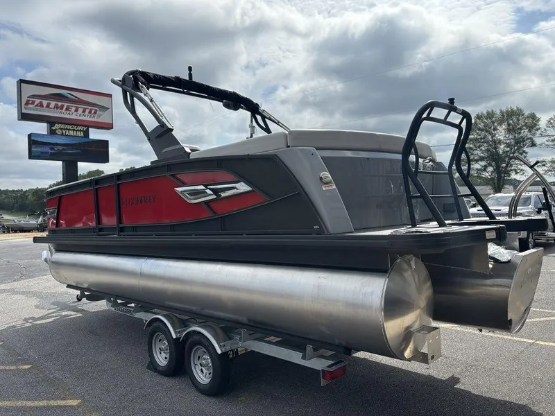 Slide: The Image of 2026 Godfrey AquaPatio 255 ULC pontoon boat on trailer at dealership. - 2