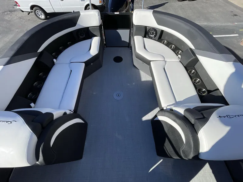 Slide: The Image of 2025 South Bay S224RS boat interior with sleek black and white seating arrangement. - 12