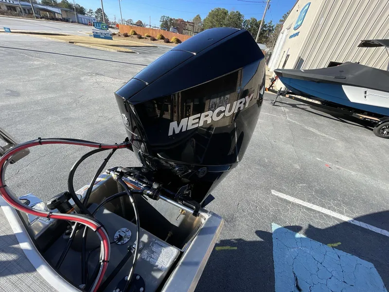 Slide: The Image of 2025 South Bay S224RS boat with Mercury outboard motor in a parking lot. - 13