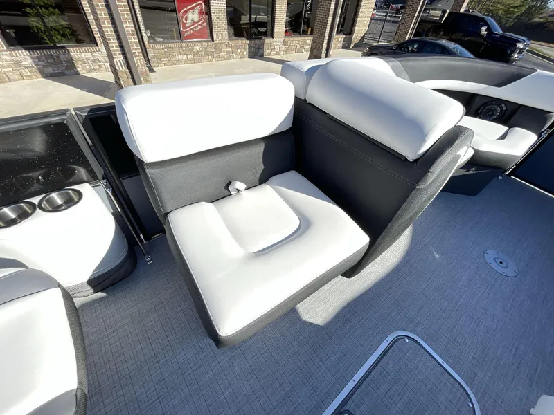 Slide: The Image of 2025 South Bay S224RS boat interior with plush seating and cup holders. - 17