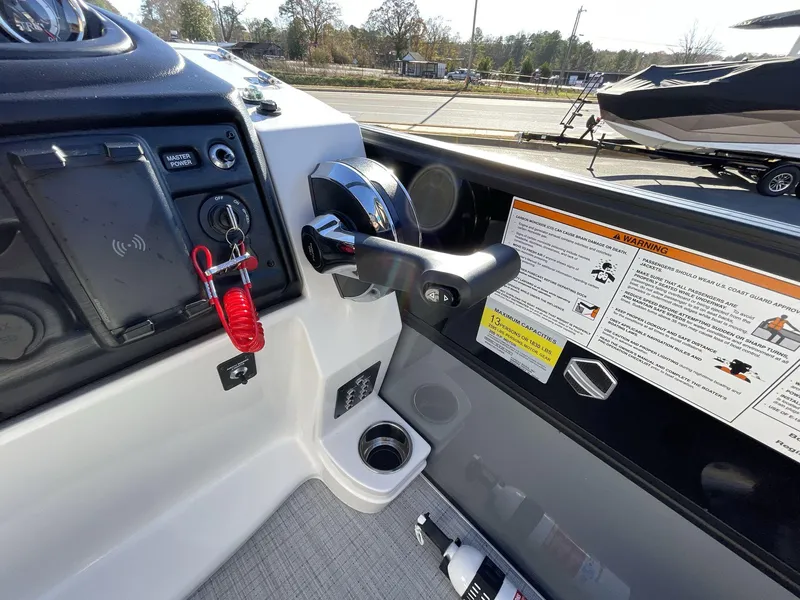Slide: The Image of Control panel of 2025 South Bay S224RS boat with throttle and safety instructions. - 21