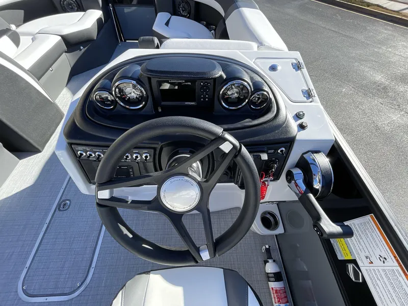 Slide: The Image of 2025 South Bay S224RS boat dashboard with steering wheel and control panel. - 22