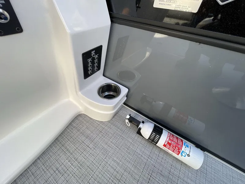 Slide: The Image of 2025 South Bay S224RS boat interior with cup holder and fire extinguisher. - 24