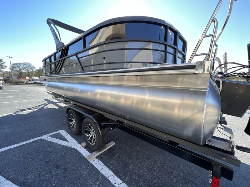 Slide: The Image of 2025 South Bay S224RS pontoon boat on trailer in parking lot, side view. - 4