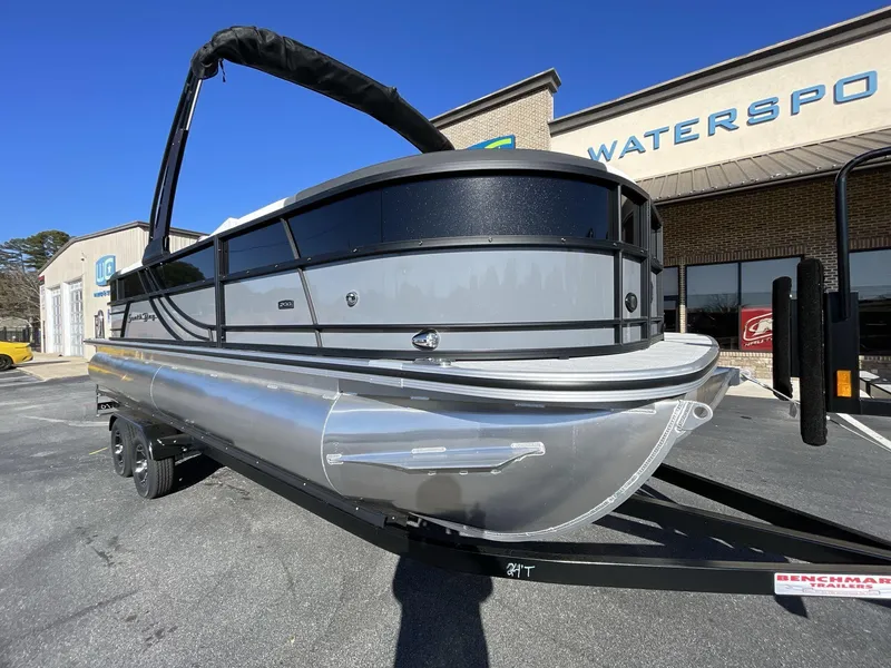 Slide: The Image of 2025 South Bay S224RS pontoon boat on trailer outside dealership. - 8