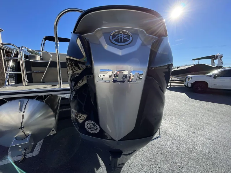 Slide: The Image of 2025 South Bay S224RS boat with powerful 200 HP engine under bright sunlight. - 10
