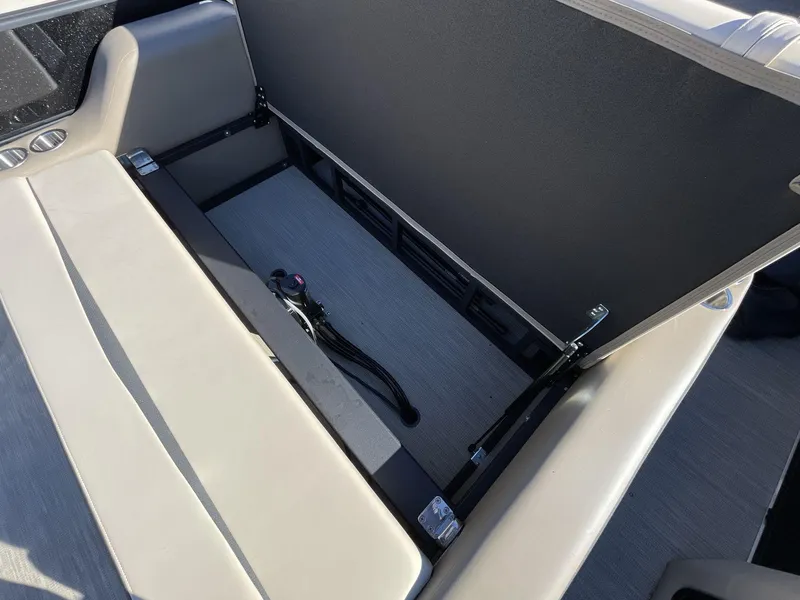 Slide: The Image of Open storage compartment in 2025 South Bay S224RS boat, showcasing interior space and design. - 12