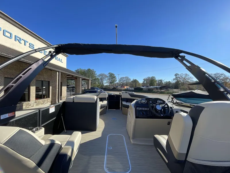 Slide: The Image of 2025 South Bay S224RS pontoon boat interior with modern seating and steering console. - 13