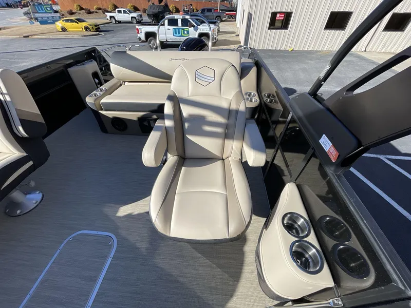 Slide: The Image of 2025 South Bay S224RS boat interior with beige seating and cup holders. - 16