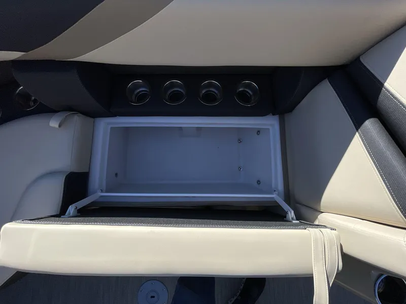 Slide: The Image of 2025 South Bay S224RS boat interior storage compartment with cup holders. - 17