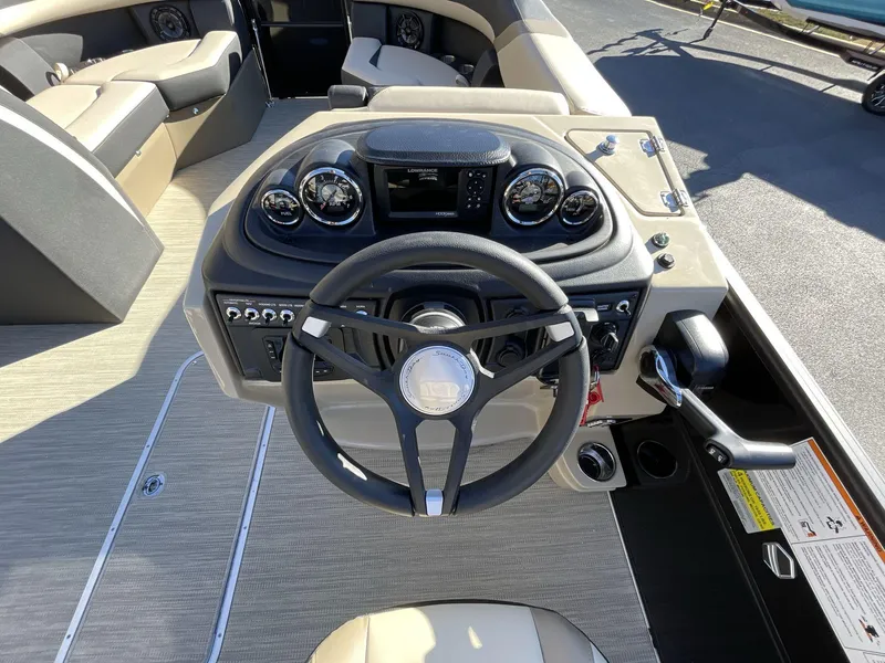 Slide: The Image of 2025 South Bay S224RS boat dashboard with steering wheel and control panel. - 20