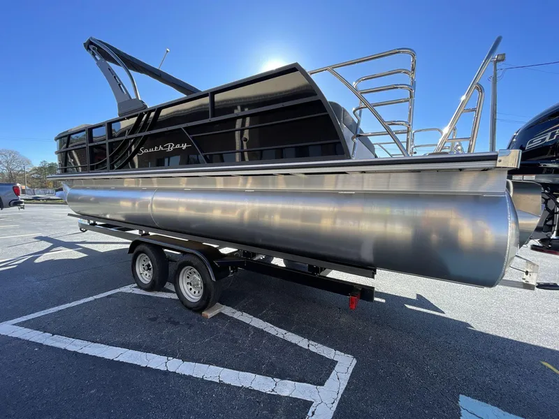 Slide: The Image of 2025 South Bay S224RS pontoon boat on trailer in parking lot. - 4