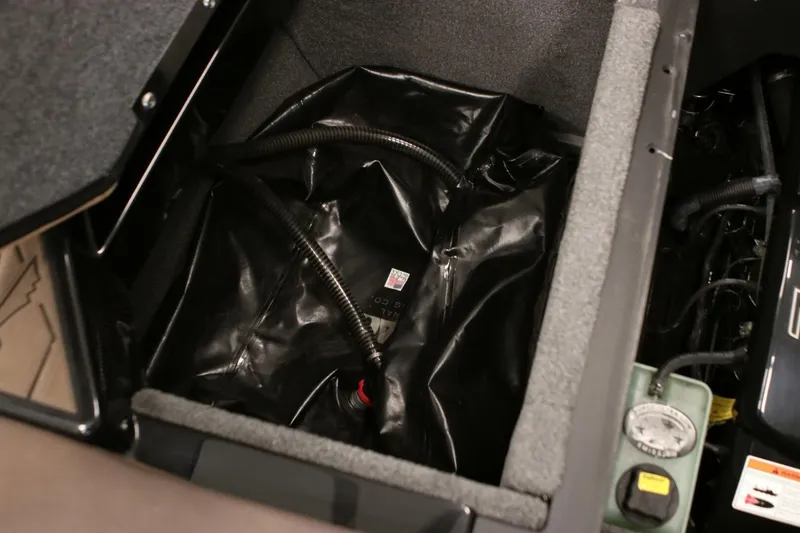 Slide: The Image of 2018 Supra SR400 storage compartment with black lining and visible wiring. - 102