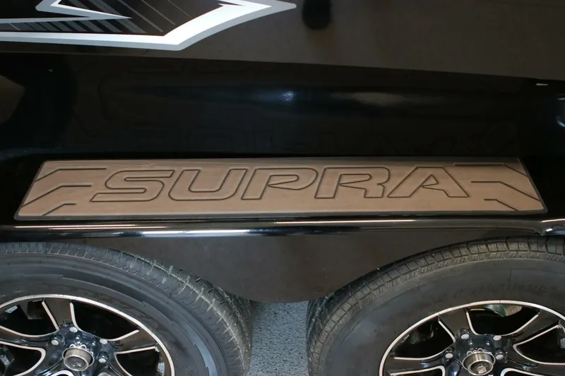 Slide: The Image of 2018 Supra SR400 logo on vehicle step above black alloy wheels. - 122