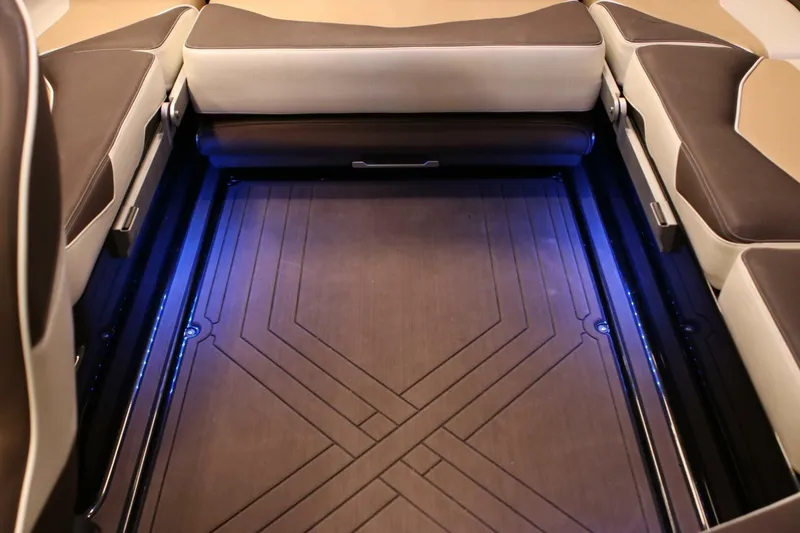 Slide: The Image of 2018 Supra SR400 boat interior with illuminated storage compartment and cushioned seating. - 32
